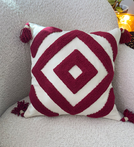 Crimsonique hand-woven cushion with intricate detailing, featuring rich textures and a warm, elegant hue for a cozy and stylish accent.