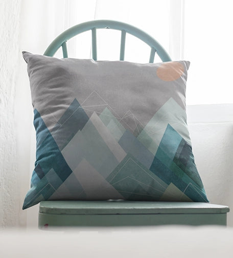 A cushion featuring bold geometric shapes and angular patterns inspired by Cubism, with a mix of vibrant colors and abstract forms for a modern, artistic touch.