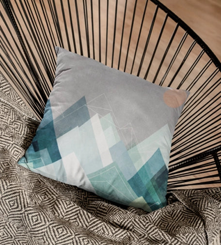 A cushion featuring bold geometric shapes and angular patterns inspired by Cubism, with a mix of vibrant colors and abstract forms for a modern, artistic touch.