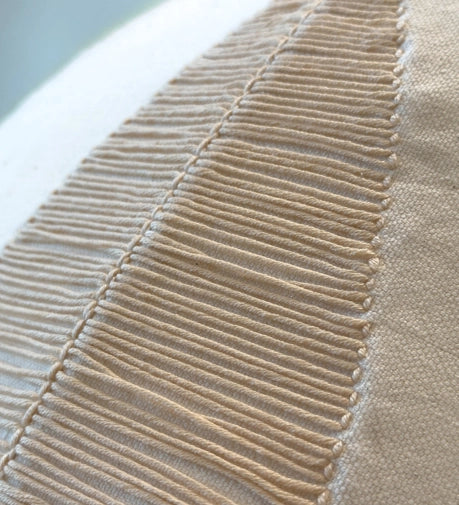 Enchant Hand Woven Cushion featuring delicate craftsmanship and an elegant, textured design.